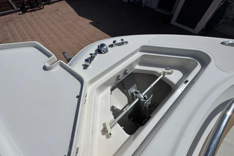 Slide: The Image of Open anchor compartment on 2020 Pioneer 222 Islander boat, showcasing storage and hardware. - 21