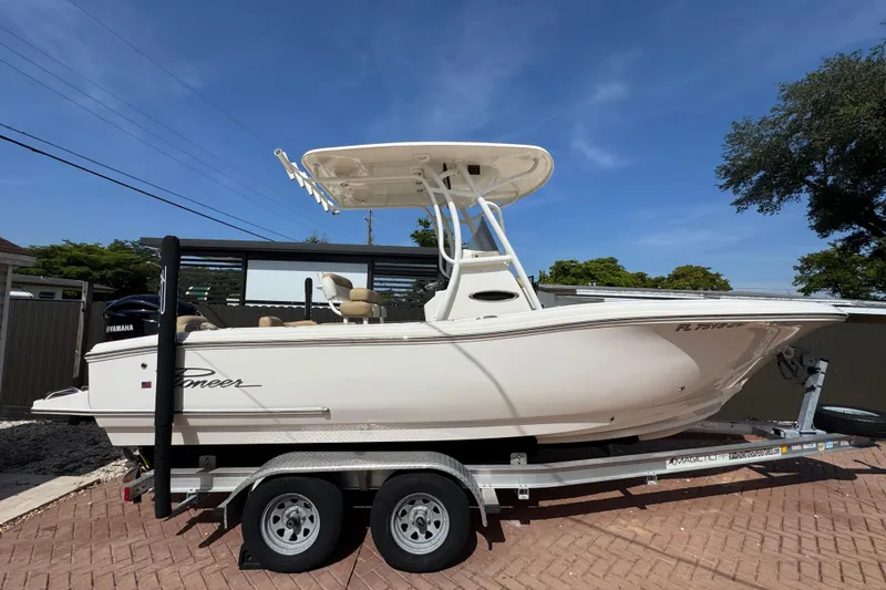 Slide: The Image of 2020 Pioneer 222 Islander boat on trailer, side view, clear sky background. - 3