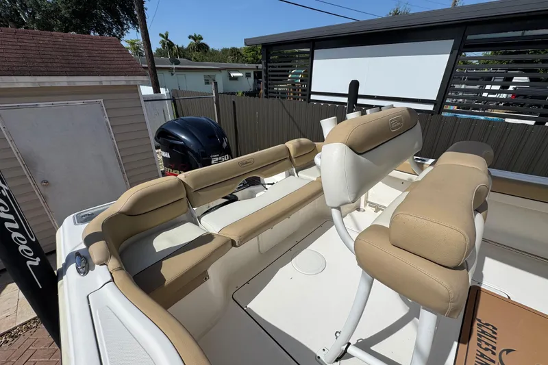 Slide: The Image of 2020 Pioneer 222 Islander boat interior with tan seating and Yamaha 250 engine. - 9