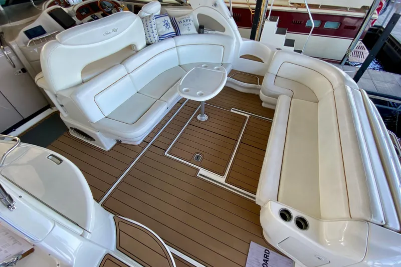 Slide: The Image of 1999 Sea Ray 460 Sundancer interior with white seating and wood flooring. - 10