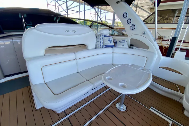 Slide: The Image of Luxurious 1999 Sea Ray 460 Sundancer yacht interior with white seating and table. - 13