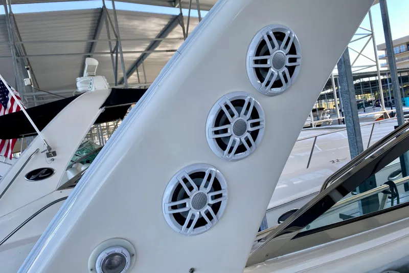 Slide: The Image of 1999 Sea Ray 460 Sundancer boat speakers on deck, docked in marina. - 17