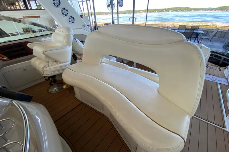Slide: The Image of 1999 Sea Ray 460 Sundancer interior with white leather seating and wood flooring. - 18
