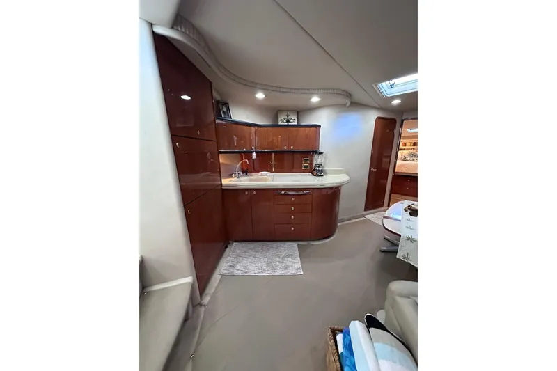Slide: The Image of Interior of 1999 Sea Ray 460 Sundancer yacht with modern kitchen and wood cabinetry. - 27