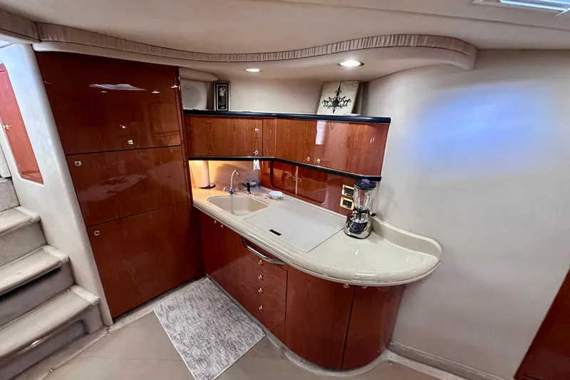 Slide: The Image of Luxurious 1999 Sea Ray 460 Sundancer yacht interior with modern kitchenette. - 28