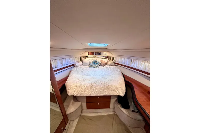 Slide: The Image of Luxurious cabin interior of 1999 Sea Ray 460 Sundancer yacht with cozy bedding. - 29