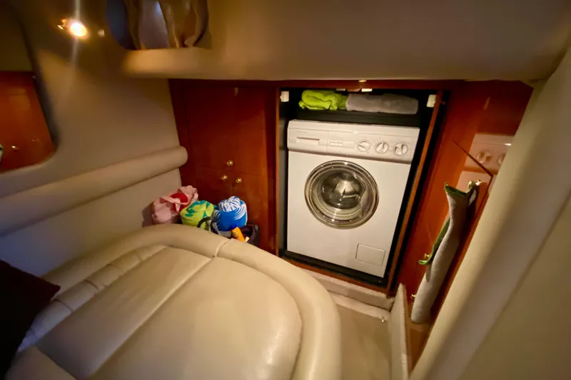 Slide: The Image of 1999 Sea Ray 460 Sundancer interior with washing machine and storage space. - 33