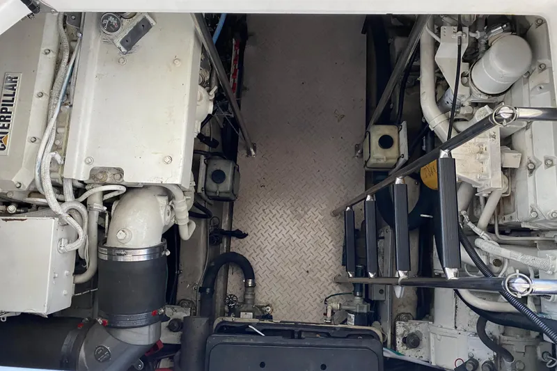 Slide: The Image of Engine room of 1999 Sea Ray 460 Sundancer with Caterpillar engines and ladder access. - 36