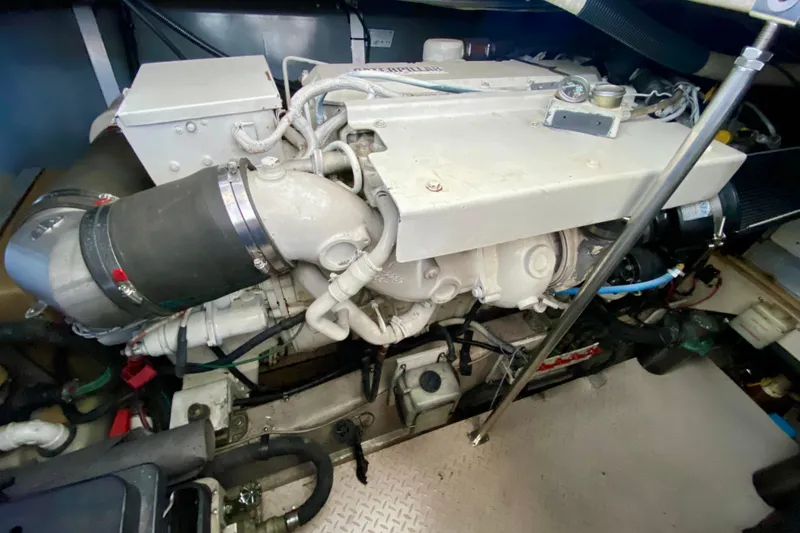 Slide: The Image of Engine compartment of a 1999 Sea Ray 460 Sundancer boat, showcasing mechanical components. - 37