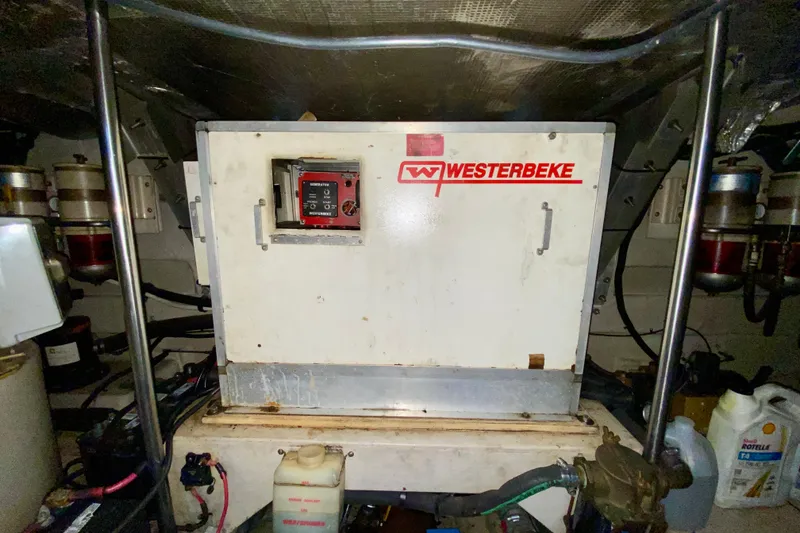 Slide: The Image of Engine room of 1999 Sea Ray 460 Sundancer with Westerbeke generator. - 40