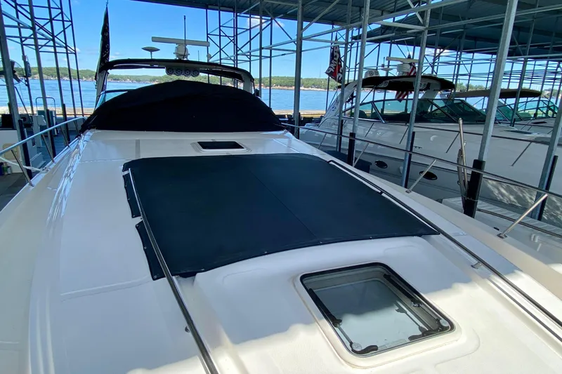 Slide: The Image of 1999 Sea Ray 460 Sundancer yacht docked under a covered marina. - 6