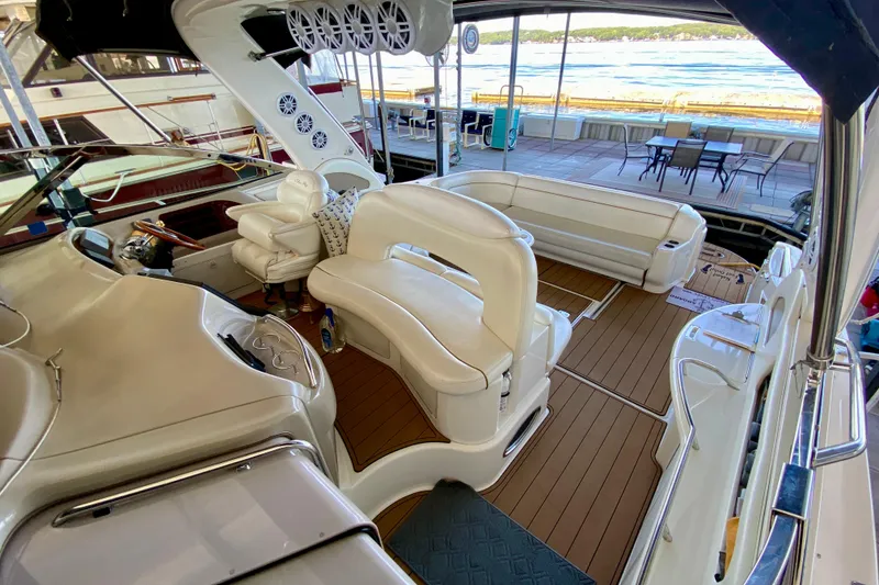 Slide: The Image of 1999 Sea Ray 460 Sundancer yacht interior with white seating and wood flooring. - 9