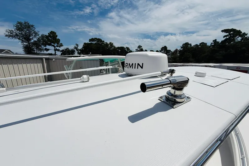 Slide: The Image of 2024 Contender 25 Open boat with Garmin radar, docked under a clear sky. - 9