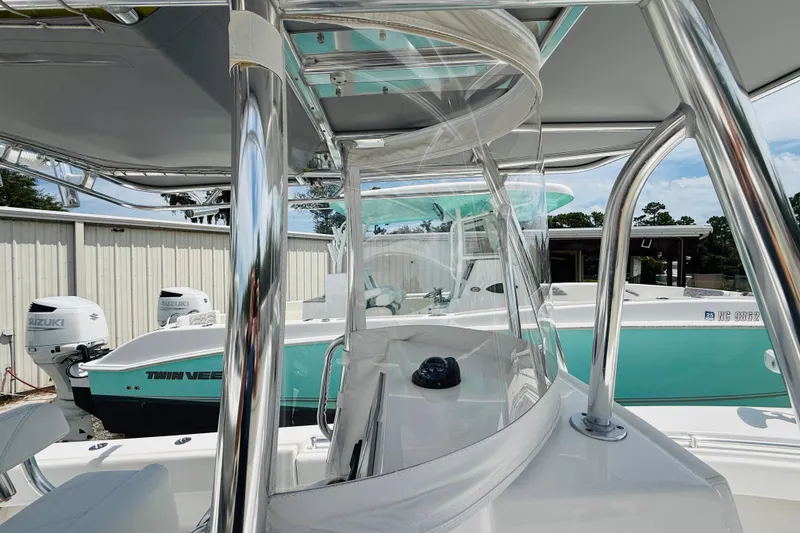 Slide: The Image of 2024 Contender 25 Open boat with sleek design and modern features, docked outdoors. - 10