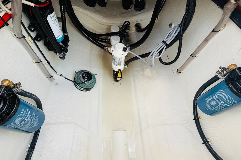 Slide: The Image of 2024 Contender 25 Open boat interior showing fuel system and wiring components. - 6