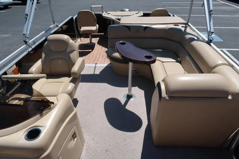 Slide: The Image of Luxurious 2013 Berkshire 231RFCSTS13 pontoon boat interior with beige seating and table. - 12