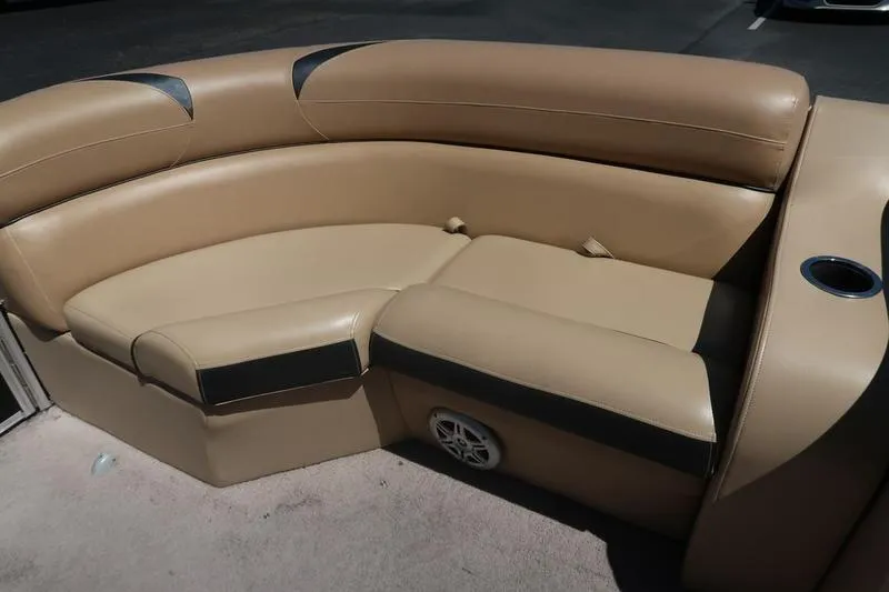 Slide: The Image of 2013 Berkshire 231RFCSTS13 boat seating, tan leather upholstery with cup holder and speaker. - 13