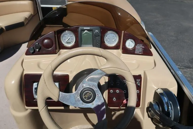 Slide: The Image of Steering console of a 2013 Berkshire 231RFCSTS13 boat with gauges and controls. - 14