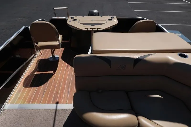 Slide: The Image of 2013 Berkshire 231RFCSTS13 pontoon boat interior with tan seating and wood-style flooring. - 15