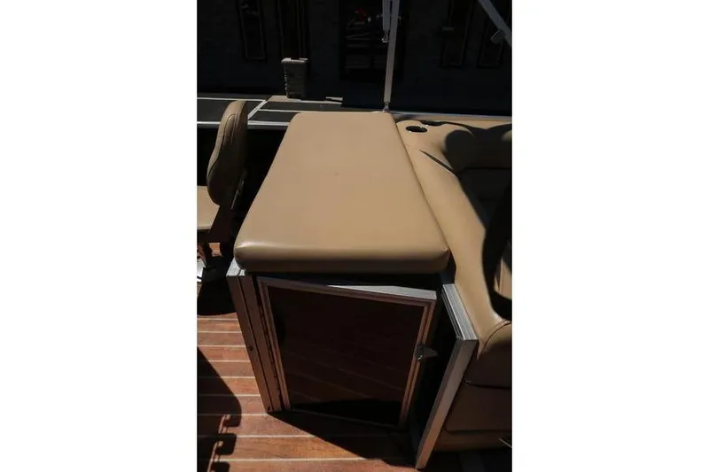 Slide: The Image of 2013 Berkshire 231RFCSTS13 boat interior with tan seating and storage compartment. - 20