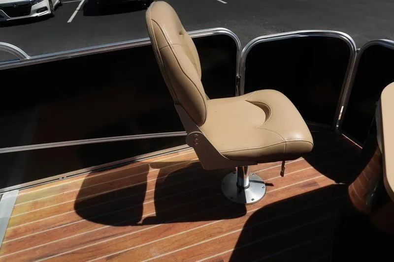 Slide: The Image of Tan boat seat on a 2013 Berkshire 231RFCSTS13, wooden deck, outdoor setting. - 22