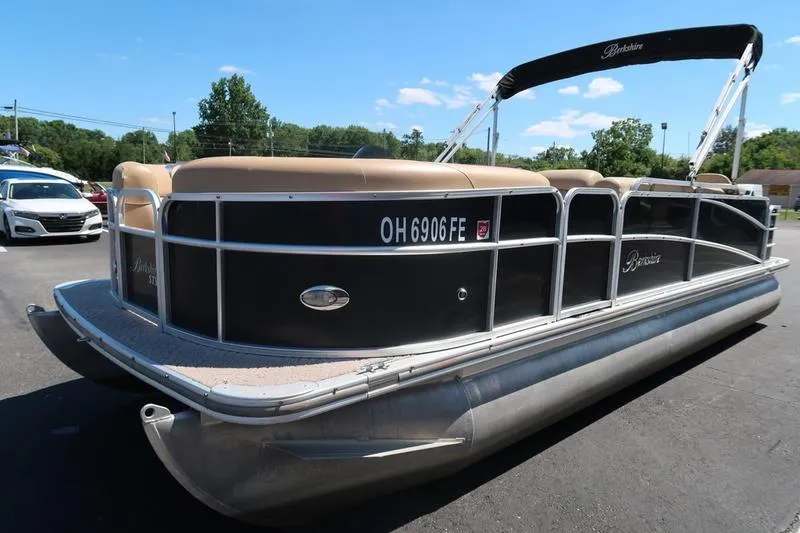 Slide: The Image of 2013 Berkshire 231RFCSTS13 pontoon boat with black exterior, parked outdoors. - 3