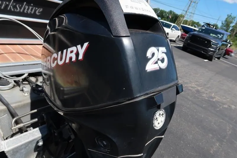 Slide: The Image of 2013 Berkshire 231RFCSTS13 with Mercury 25 outboard motor in parking lot. - 4