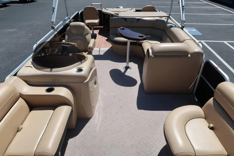 Slide: The Image of 2013 Berkshire 231RFCSTS13 pontoon boat interior with beige seating and table. - 8