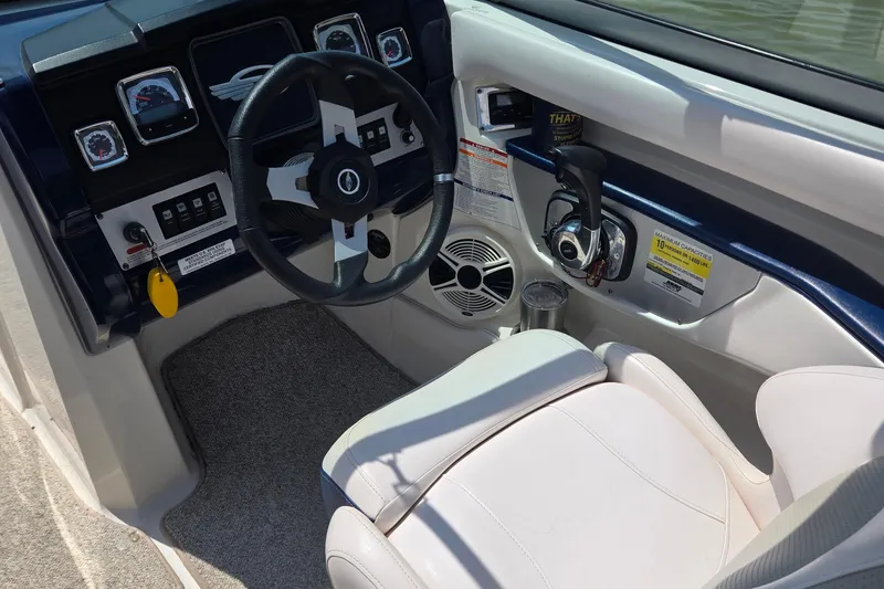 Slide: The Image of Interior view of 2010 Chaparral 206 SSi boat cockpit with steering wheel and controls. - 10