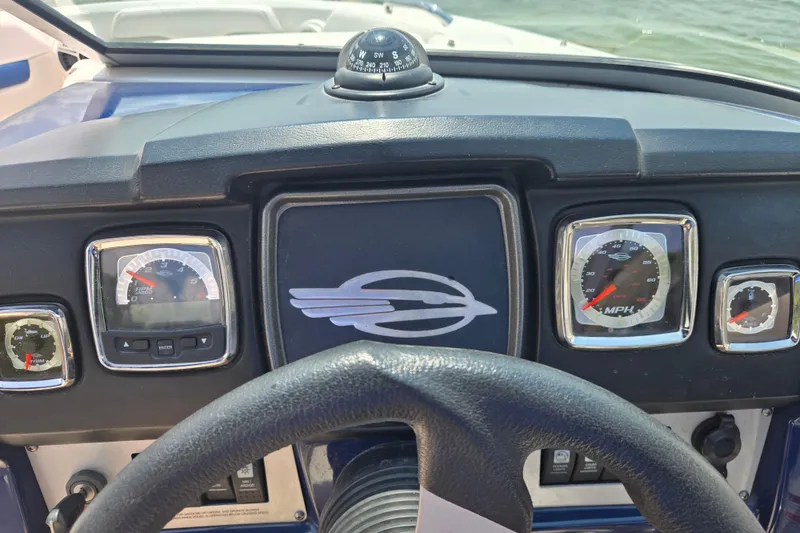 Slide: The Image of Dashboard of 2010 Chaparral 206 SSi boat with gauges and compass. - 13