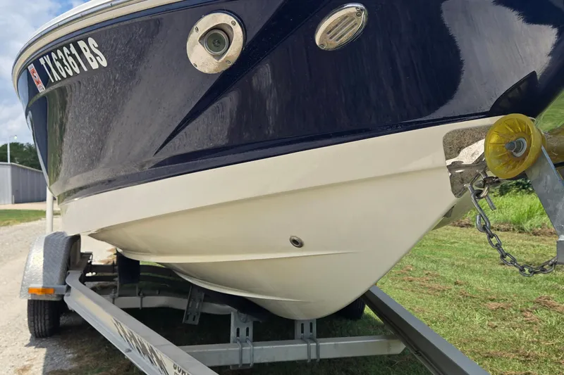 Slide: The Image of 2010 Chaparral 206 SSi boat on trailer, close-up view of hull and registration. - 5