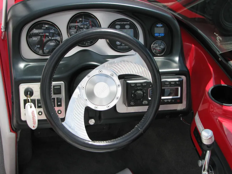 Slide: The Image of Dashboard of a 2004 MB B52-21 V/SK boat with steering wheel and gauges. - 10