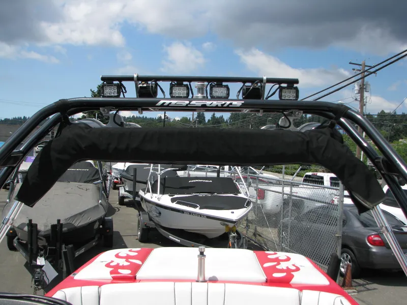 Slide: The Image of 2004 MB B52-21 V/SK boat with wakeboard tower and padded roll bar in a marina. - 12