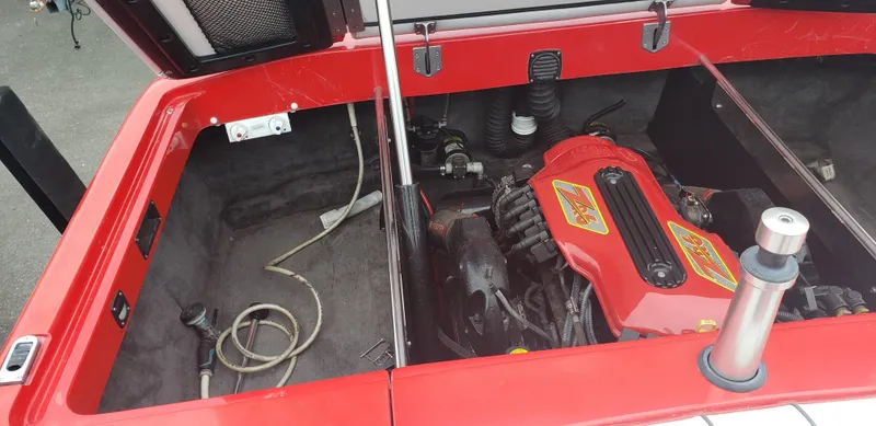 Slide: The Image of Open engine compartment of 2004 MB B52-21 V/SK boat, showcasing red engine components. - 13