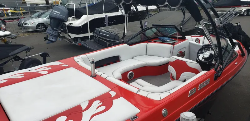 Slide: The Image of 2004 MB B52-21 V/SK boat with red and white interior, docked in a marina. - 4