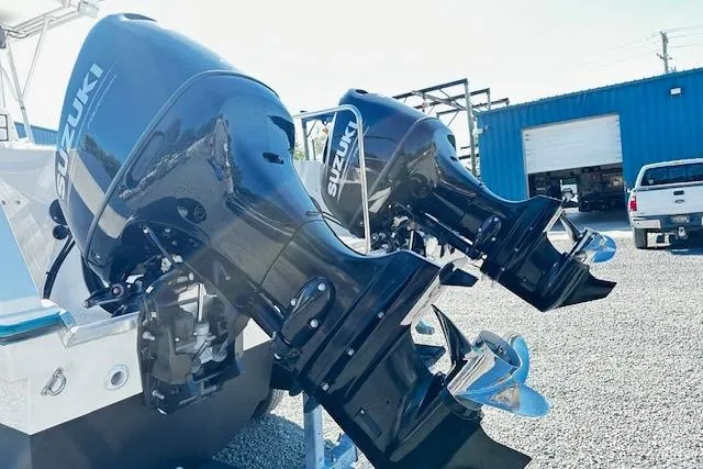 Slide: The Image of Twin Suzuki outboard motors on a 1997 Sea Cat Catamaran, parked on gravel. - 22