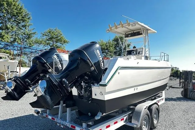 Slide: The Image of 1997 Sea Cat Catamaran with dual Suzuki engines on trailer, parked outdoors. - 3