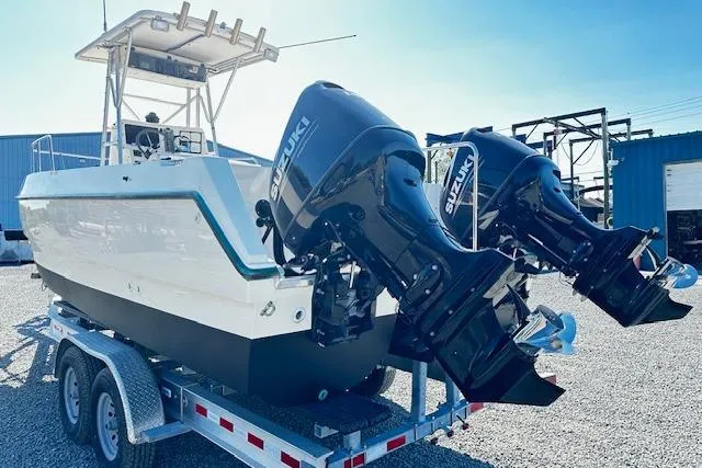 Slide: The Image of 1997 Sea Cat Catamaran with dual Suzuki outboard motors on a trailer. - 4