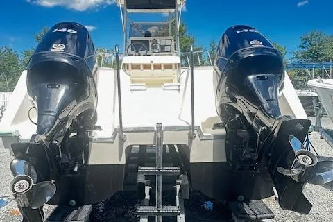 Slide: The Image of 1997 Sea Cat Catamaran with dual outboard motors, docked under a clear blue sky. - 5
