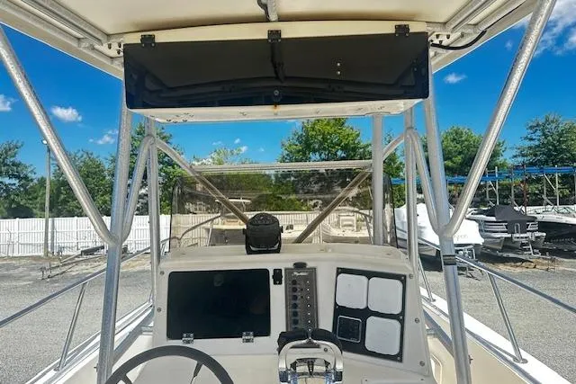 Slide: The Image of 1997 Sea Cat Catamaran helm with steering wheel and control panel, docked outdoors. - 6