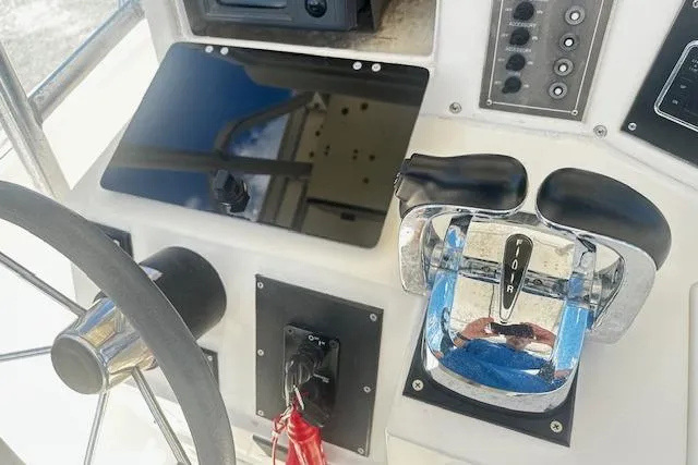 Slide: The Image of Control panel of a 1997 Sea Cat Catamaran with steering wheel and throttle levers. - 7