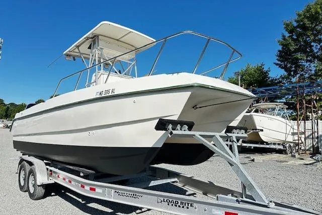 The Image of 1997 Sea Cat Catamaran on trailer under clear blue sky. - 0