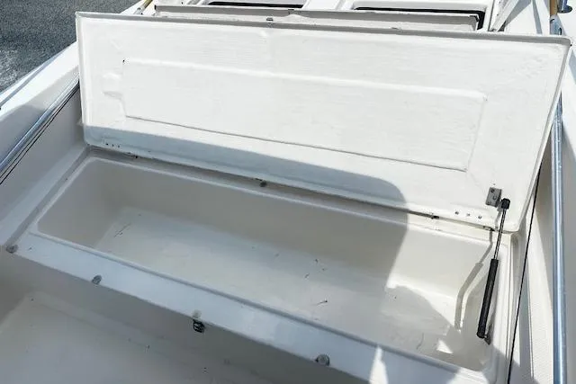 Slide: The Image of 1997 Sea Cat Catamaran storage compartment with open lid, showcasing interior space. - 17