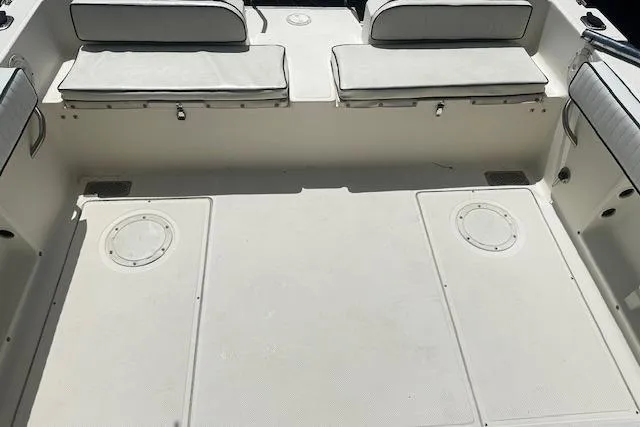 Slide: The Image of 1997 Sea Cat Catamaran interior with white cushioned seating and spacious deck area. - 19