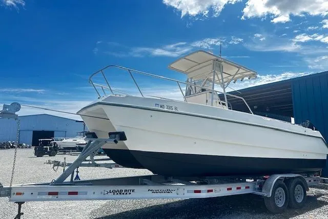 Slide: The Image of 1997 Sea Cat Catamaran on trailer, parked outdoors under a clear blue sky. - 2