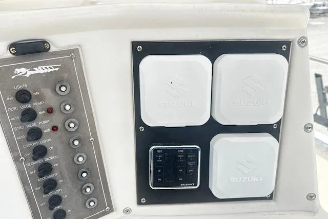 Slide: The Image of Control panel of a 1997 Sea Cat Catamaran featuring Suzuki components and switches. - 8