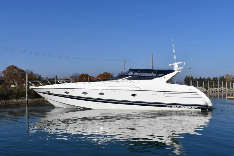 The Image of 1996 Sunseeker 55 CAMARGUE yacht on calm water under clear blue sky. - 0