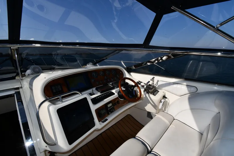 Slide: The Image of Helm of 1996 Sunseeker 55 CAMARGUE yacht with modern controls and leather seating. - 12