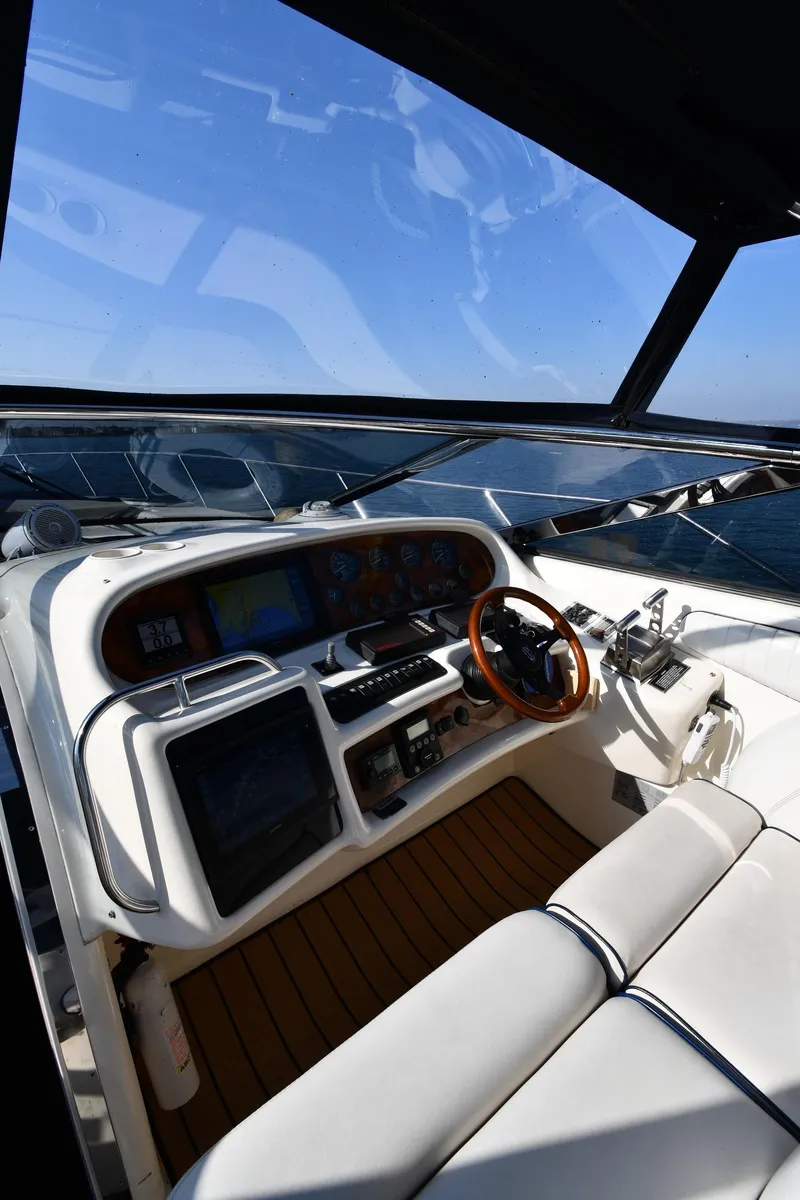 Slide: The Image of 1996 Sunseeker 55 CAMARGUE yacht cockpit with steering wheel and navigation controls. - 13