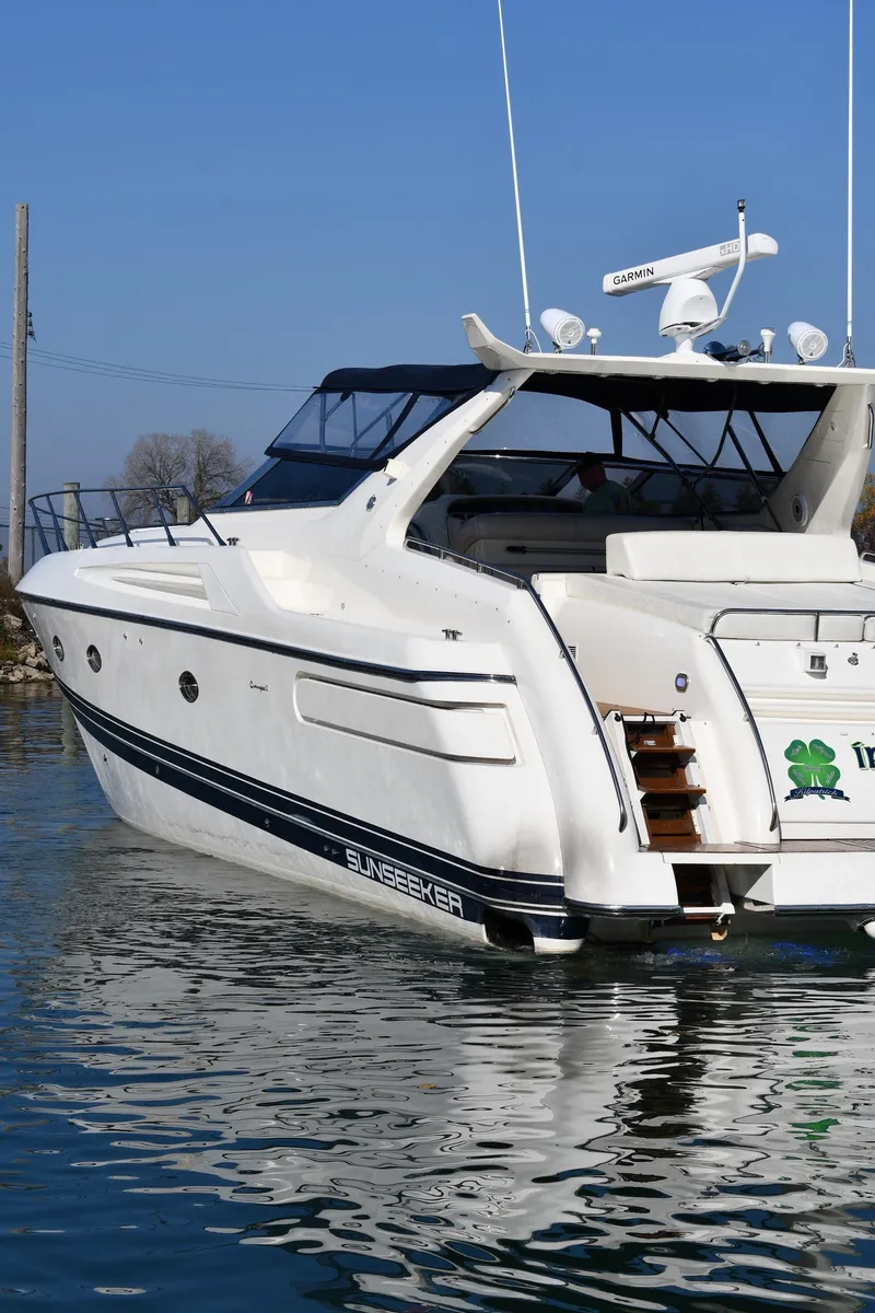 Slide: The Image of 1996 Sunseeker 55 CAMARGUE yacht on calm water, rear view. - 2